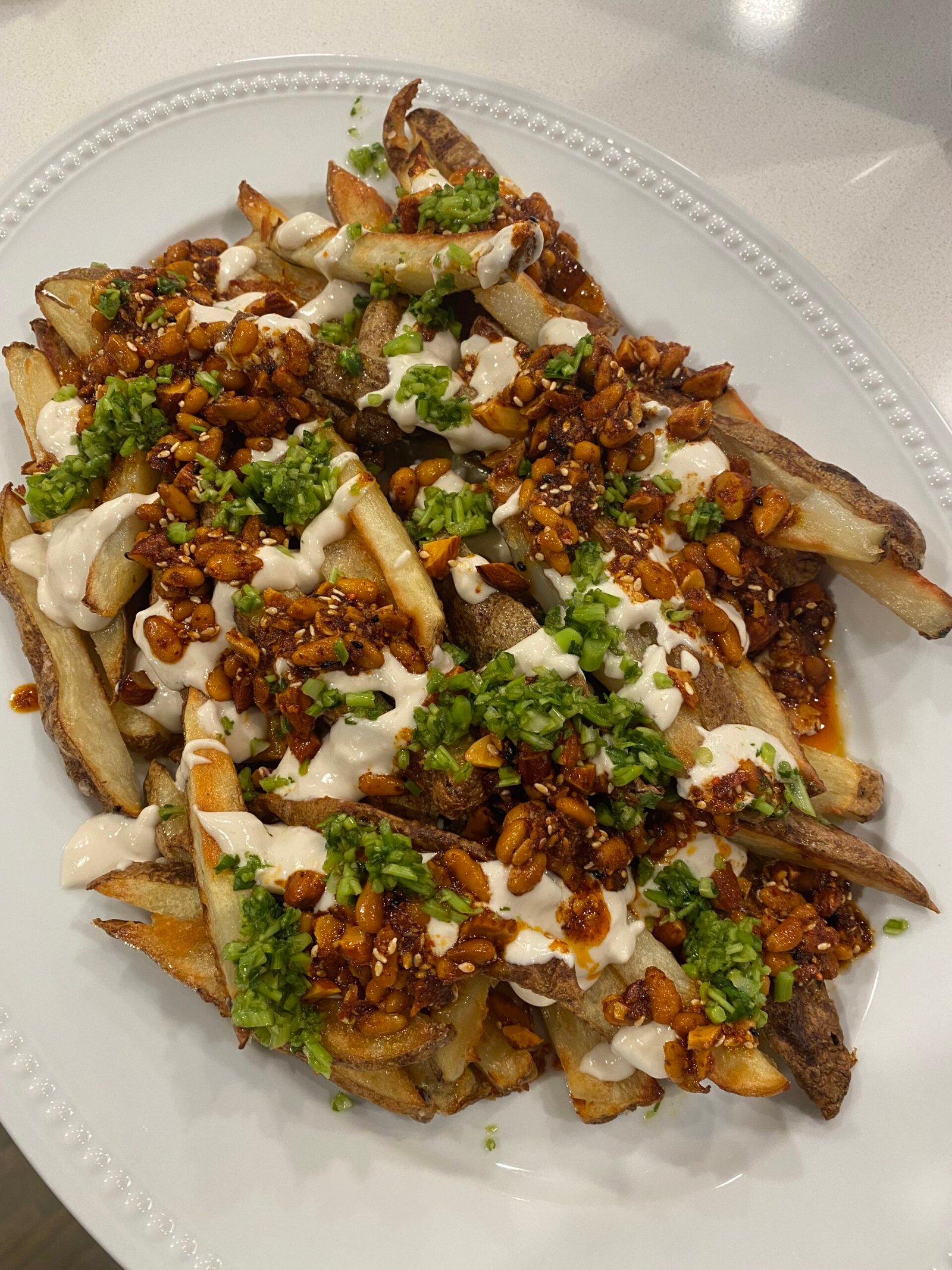 Oven fries with tahini yogurt and smoky sweet nuts